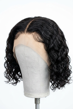 Deep wave short bob wig on a stand showing lace front detail and wave texture